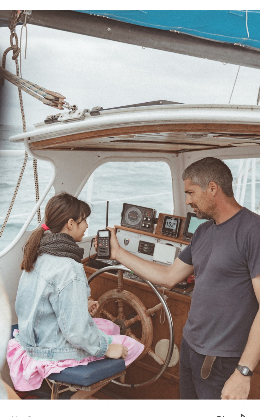 Skipper showing onboard radio equipment to a young guest
