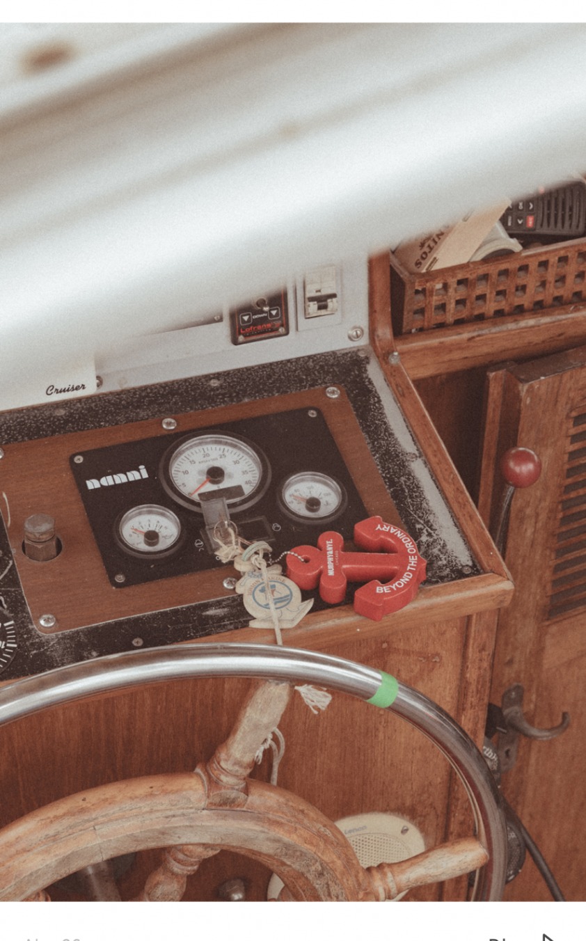 Wooden helm and sailing instruments inside the cockpit