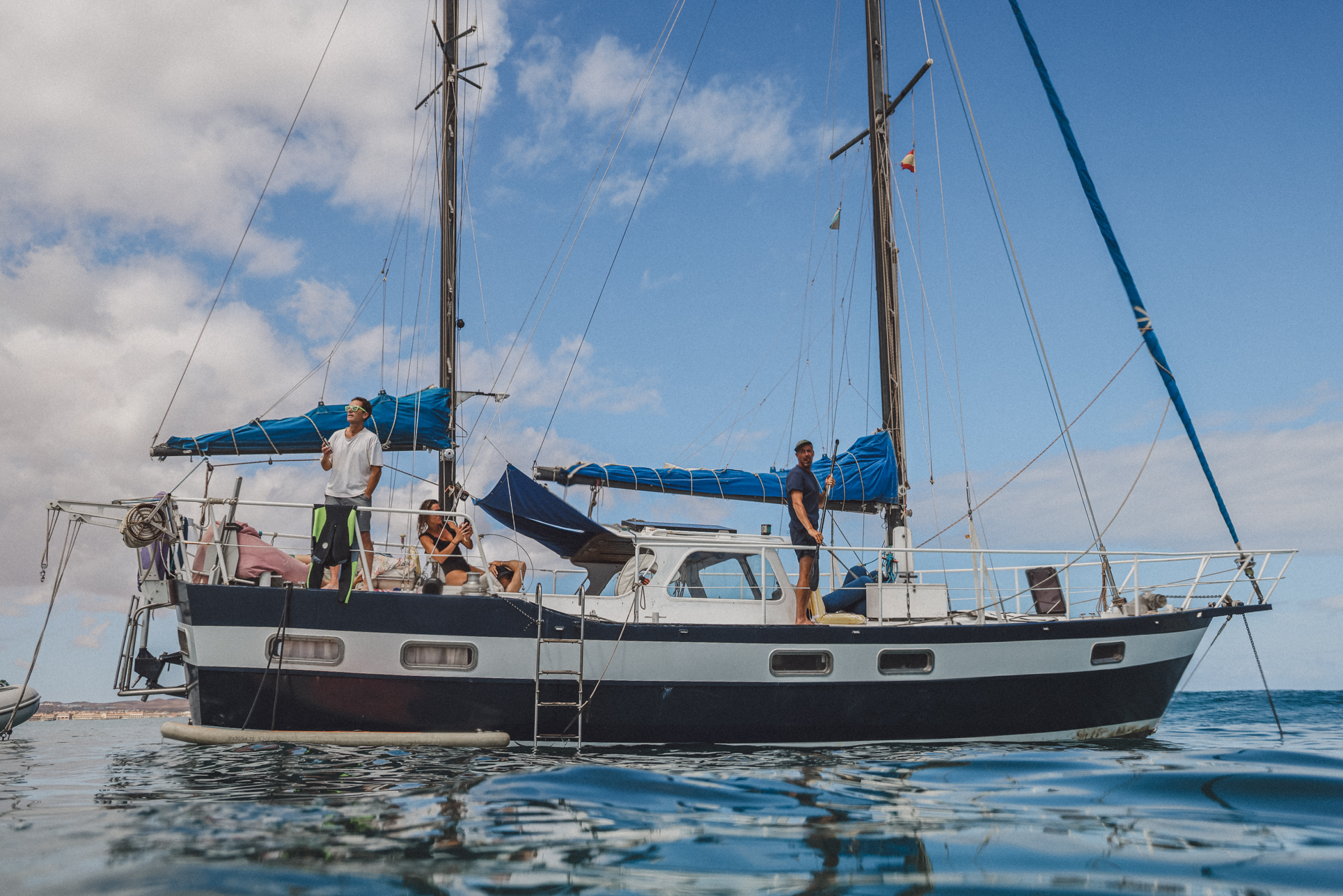 Sailing yacht Olivia with guests on deck in the turquoise water off Corralejo