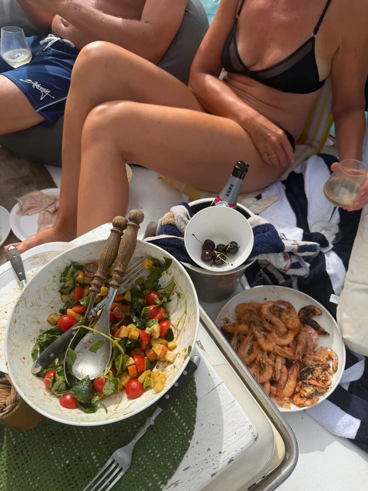 Shared salad and grilled prawns served on board